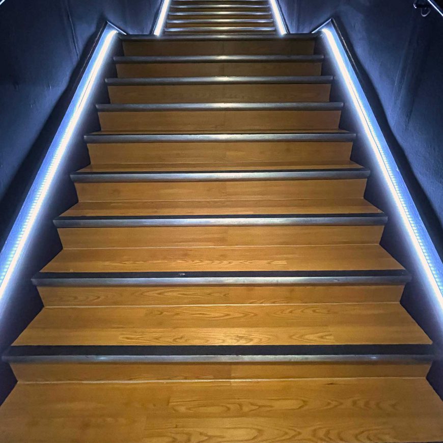 Illuminated staircase for Team Rees Gym by Sauce signage and displays