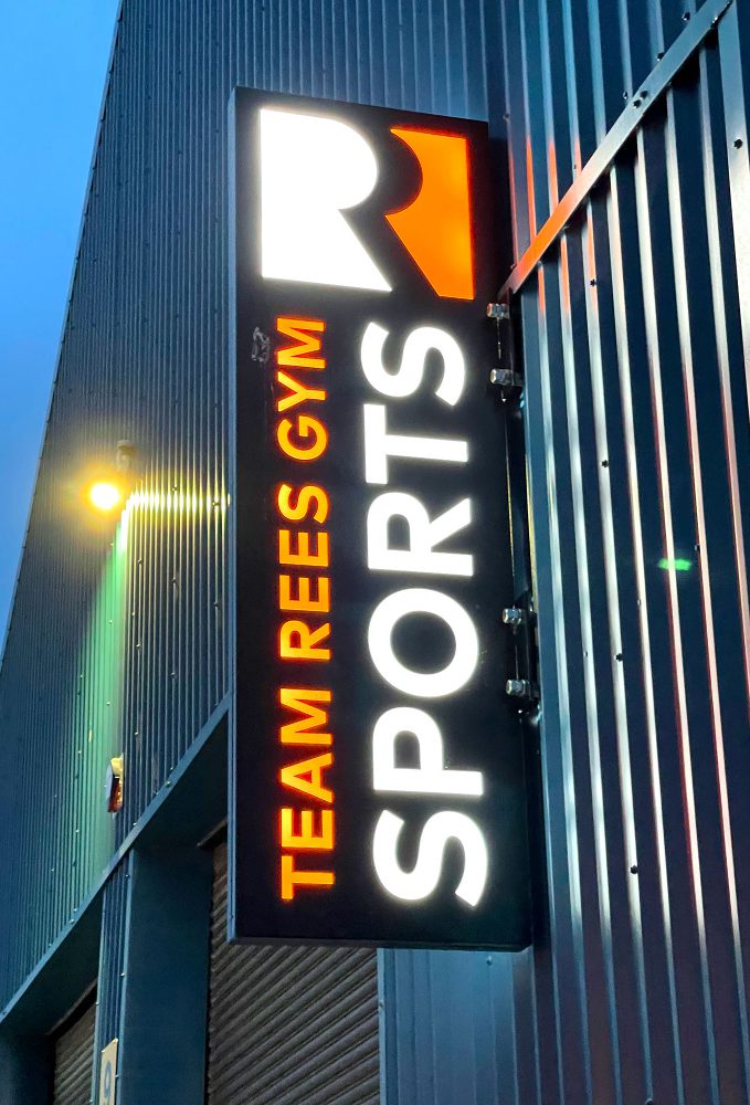 Team Rees illuminated projecting sign at night, by Sauce