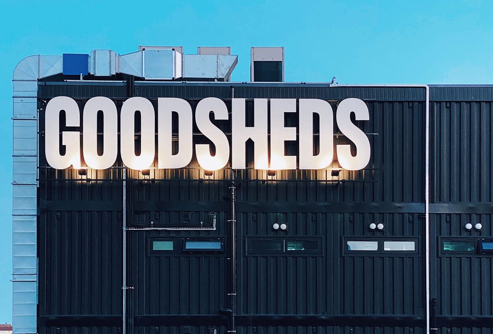 Goodsheds signage Barry spotlit on a shipping container