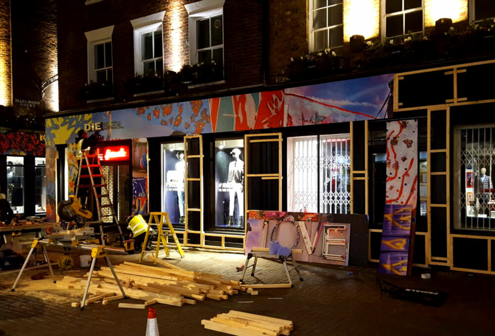 Work in progress at the Diesel Store Carnaby Street as Sauce applies vinyl graphics at night